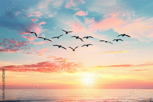 Flock of birds flying over a serene ocean at sunrise with colorful clouds in the sky. Concept of freedom, nature, and tranquility.
