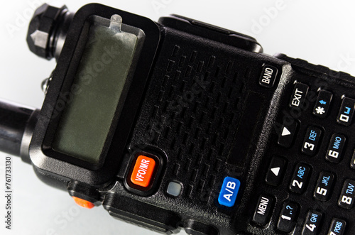 One handheld radio with antenna on white background