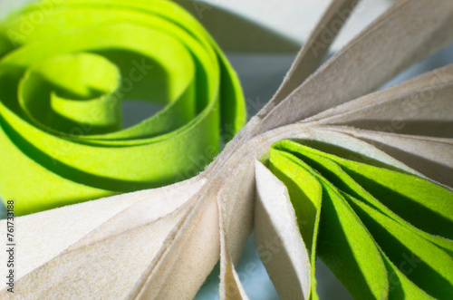 Quilling from white and green paper, close-up