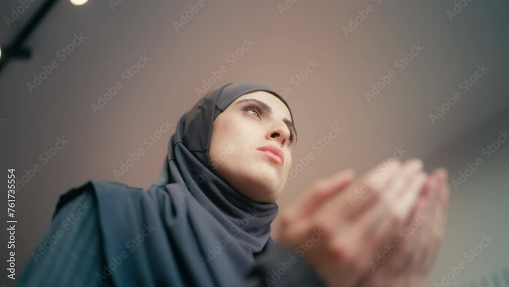 Bottom view of Muslim woman in hijab praying, religious ritual, faith in God Bottom view of Muslim woman in hijab praying, religious ritual, faith in God