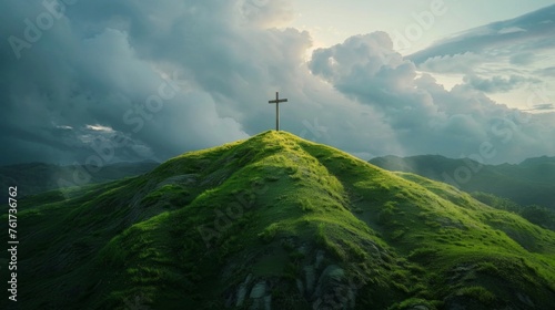 Christian cross on top of a green hill