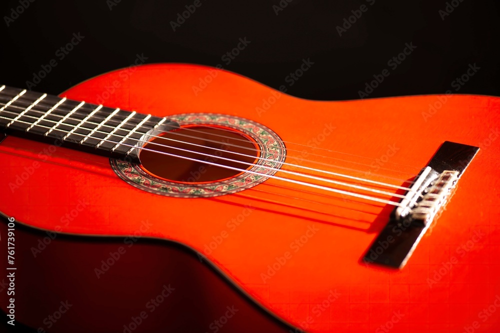 Classical Spanish flamenco guitar close up, dramatically lit isolated on black background with copy space. Classical Spanish flamenco guitar close up, dramatically lit isolated on black background with copy space.