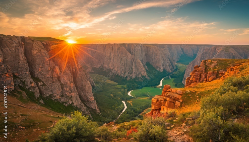  the sun is setting over a canyon with a river running between it and a mountain range with a river running between it.