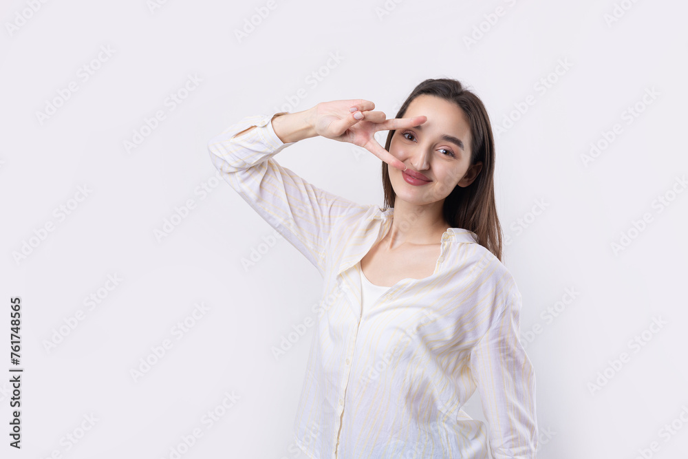 Smiling woman raised her hand palm up and forward like waving. Smiling woman raised her hand palm up and forward like waving.