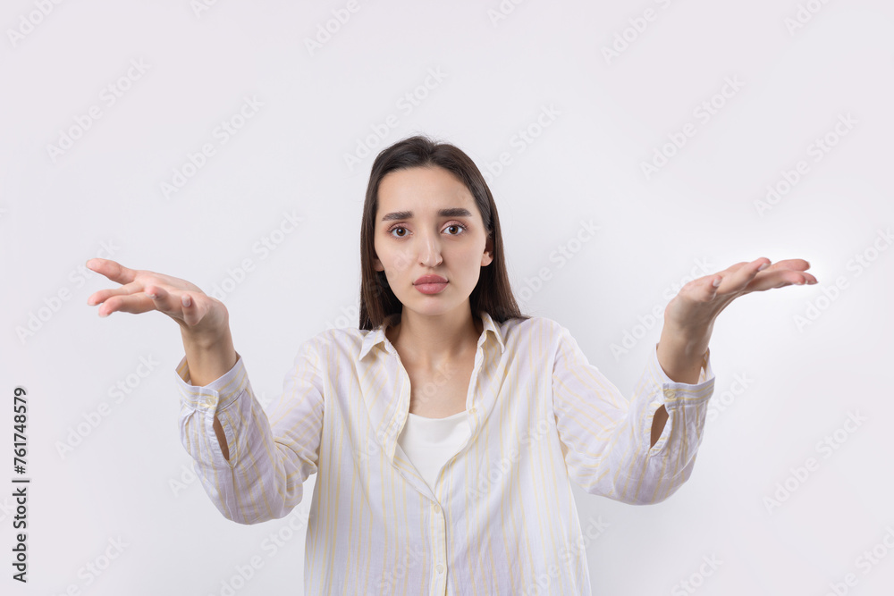 Young beautiful woman with facial expression of surprise standing over white background. Young beautiful woman with facial expression of surprise standing over white background.