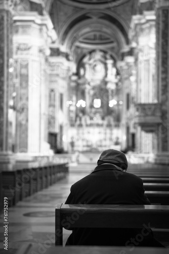 Older gentleman sitting in the church. Black and white photo. Selective focus. © Marcin