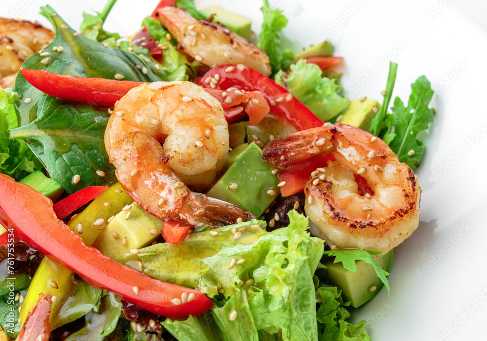 Healthy fresh salad with shrimp or prawns, avocado, lettuce, spinach, sesame, bell pepper and sauce in plate isolated on white background. Healthy food, top view Healthy fresh salad with shrimp or prawns, avocado, lettuce, spinach, sesame, bell pepper and sauce in plate isolated on white background. Healthy food, top view