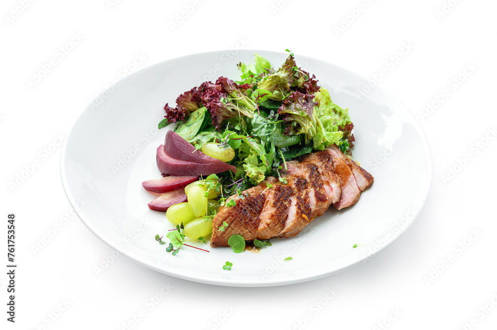 Healthy salad with medium rare beef steak, pear, grapes, lettuce, arugula, and sauce in plate isolated on white background. Healthy food, top view Healthy salad with medium rare beef steak, pear, grapes, lettuce, arugula, and sauce in plate isolated on white background. Healthy food, top view