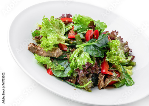 Healthy salad with grilled beef meat, tomatoes, bell pepper, lettuce, arugula, french bean and sauce in plate isolated on white background. Healthy food, top view