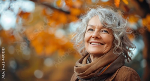A woman with gray hair and a scarf smiles directly at the camera.