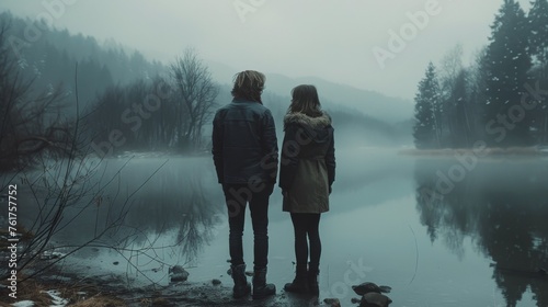 Two Hikers Admiring Mountain Lake © olegganko