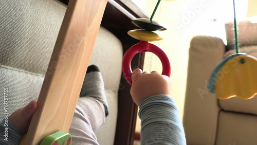 Baby toddler infant hands holding toy playing learning about the world