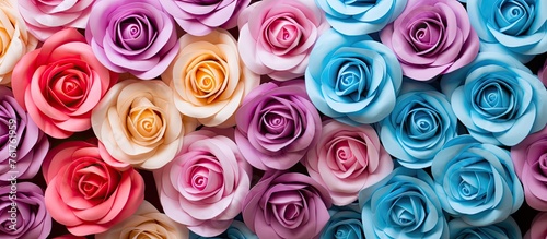 A vibrant display of hybrid tea roses in shades of purple, pink, and blue, showcasing the beauty of these colorful flowers stacked on a table for a stunning botanical photograph photo