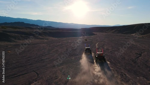 Side By Side UTVs Racing through the Desert Canyon photo