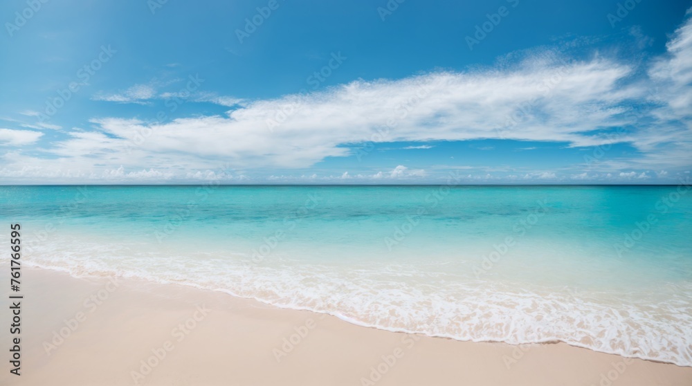 Deep blue sea embraces a sandy shore beneath a calm sky filled with clouds 