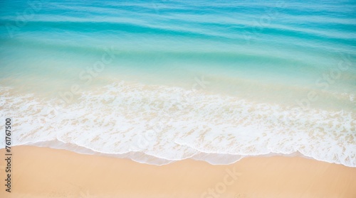 Easy waves softly touch the sandy beach under a clear sky 