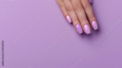 Hand with purple nail polish over lilac