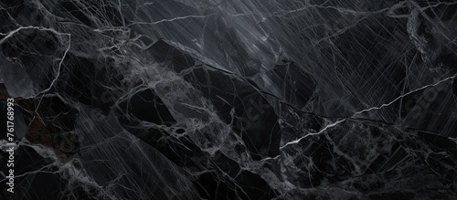 A detailed closeup of a monochrome black marble texture, resembling a dark and freezing pattern. The image captures the essence of darkness and elegance