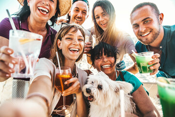 Group of happy people enjoying cocktail party sitting at bar restaurant - Happy friends toasting gin tonic and mojitos together - Food and beverage life style concept