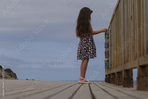 Girl throwing garbage on the beach recycle