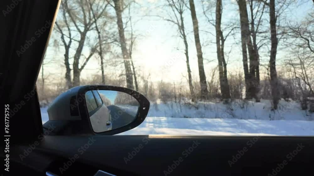 Sunlight shines through the trees, beautiful winter nature. Car window view, background, landscape. Car speeding on a road through winter forest Sunlight shines through the trees, beautiful winter nature. Car window view, background, landscape. Car speeding on a road through winter forest