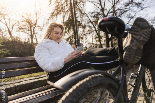 Woman Sitting on a Bench Using a Cell Phone