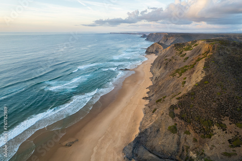 Sunset over amazing Cordoama sandy beach in Portugal. Aerial drone view