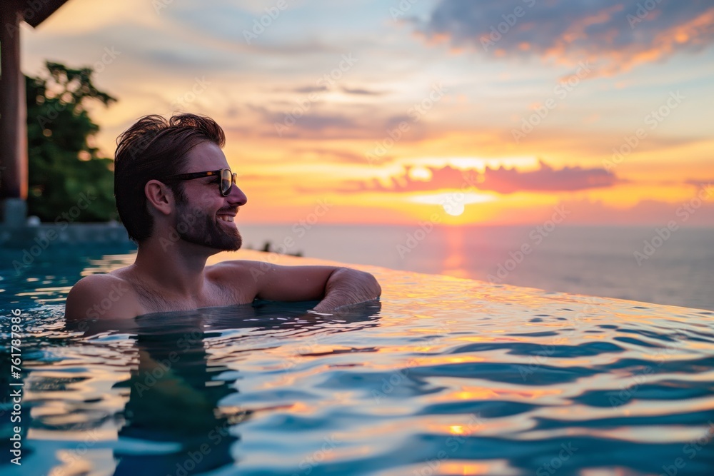 Young man enjoys a serene moment in an infinity pool overlooking a stunning sunset Young man enjoys a serene moment in an infinity pool overlooking a stunning sunset