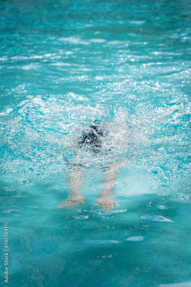 Splashing water while diving in swimming pool
