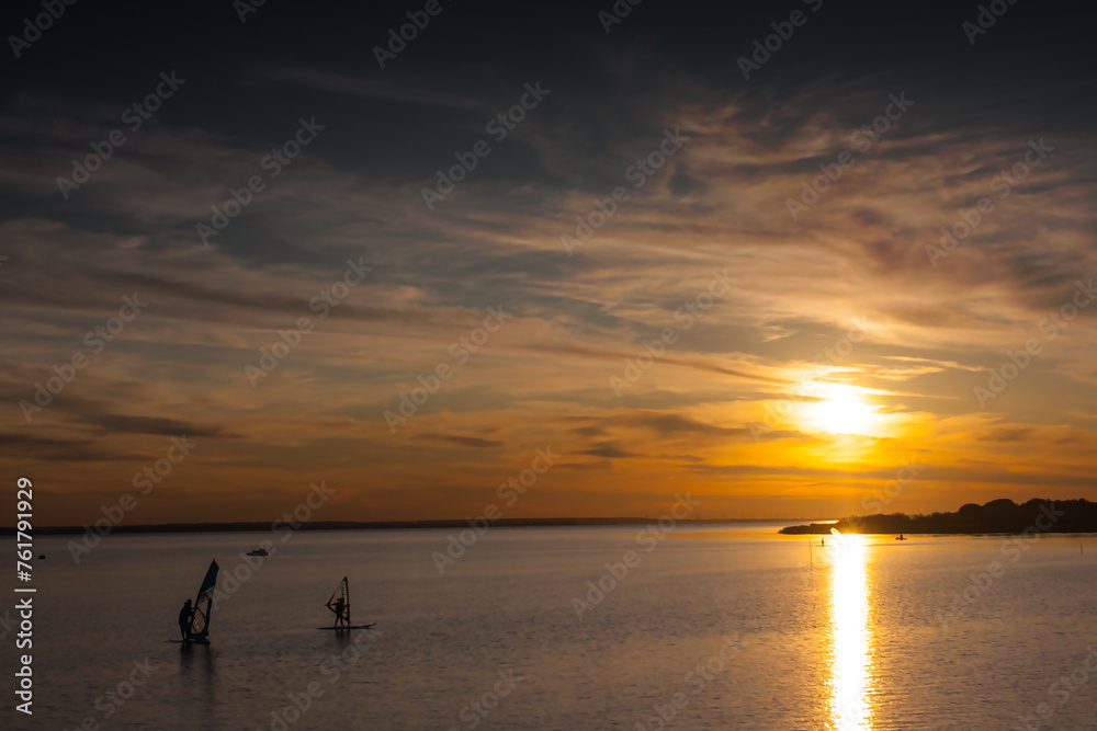 Windsurfing on the lake at sunset