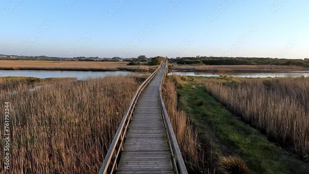 Wooden structure on the footbridges of Barrinha de Esmoriz with water from the Paramos lagoon, Portugal. Wooden structure on the footbridges of Barrinha de Esmoriz with water from the Paramos lagoon, Portugal.