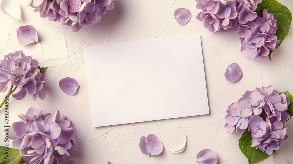 top view flat lay beautiful blank paper card mockup with purple Hydrangea macrophylla flowers on white textured background with copy space. floral frame