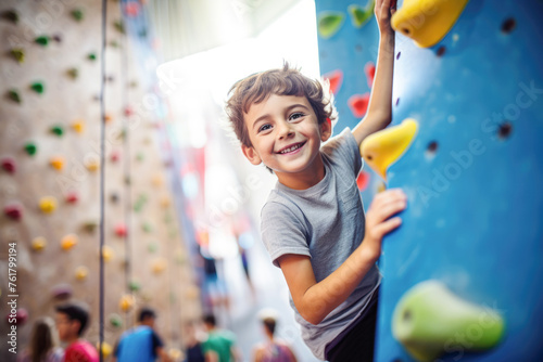 Obraz na płótnie A young boy eagerly tackling a climbing wall at the gym, mastering the art of bouldering with determination. w salonie