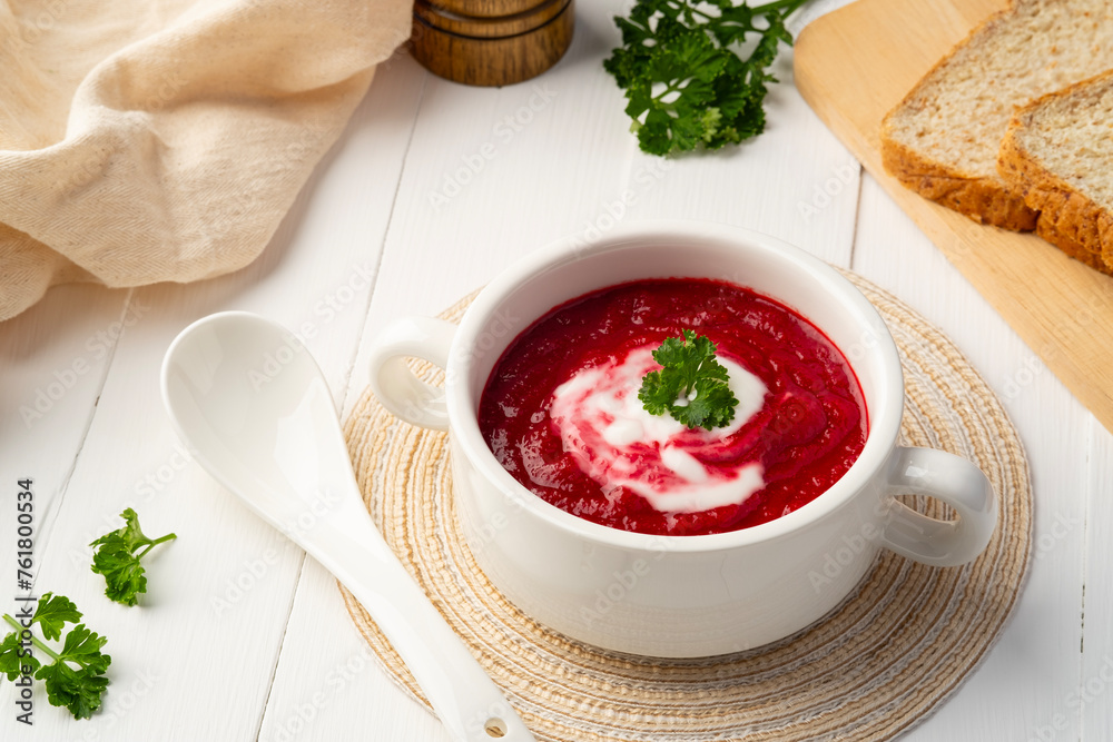 Easy beetroot soup with sour cream,creamy soup in a white bowl. Easy beetroot soup with sour cream,creamy soup in a white bowl.
