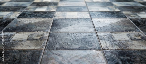 A closeup view of a checkered pattern tiled floor made of composite material in grey color, resembling a chessboard effect