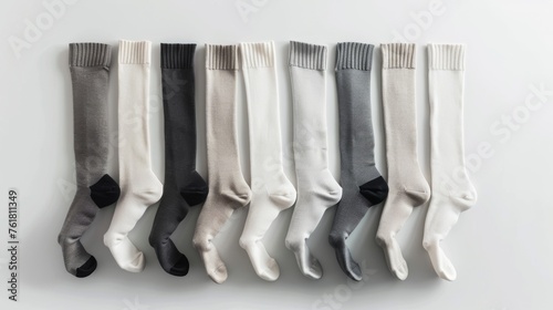 A comprehensive set of long socks in shades of white, gray, and black, presented against a white background for clear comparison