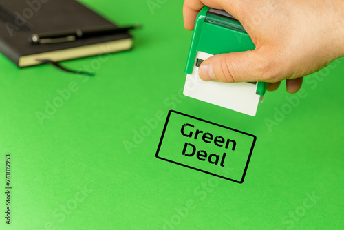 Green deal, European green deal environmental concept, Clerk puts an approving stamp with the words Green deal, copy space