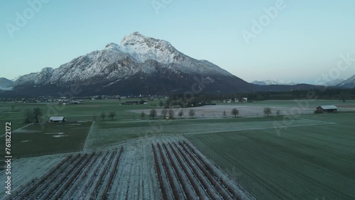 Scenic drone footage of the snowcapped Untersberg Mountain in Salzburg, Austria. Shot via drone in 4k at both sunrise and sunset. Along with the small town at the bottom of the mountain. photo