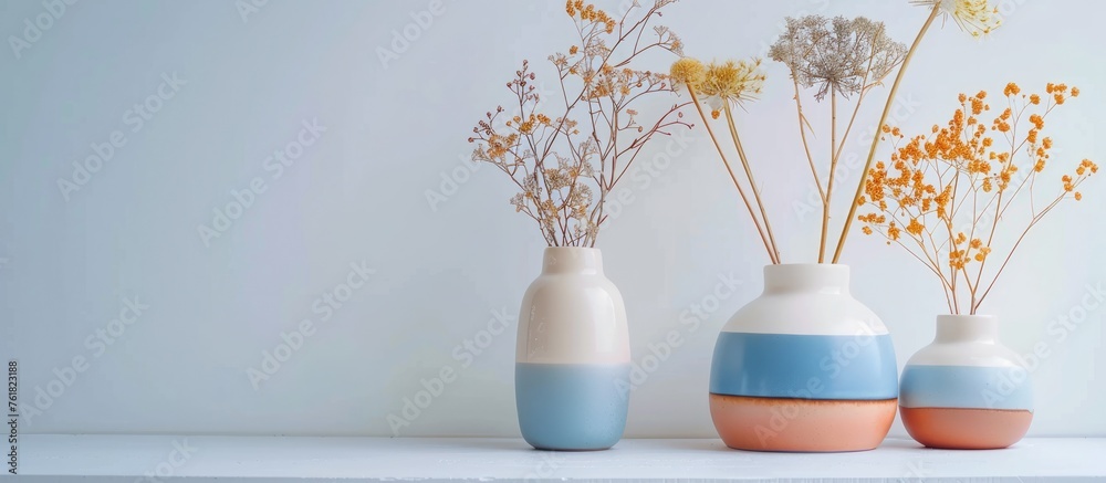 Arrangement of ceramic flower vases in contrasting two-tone colors on a white backdrop. Arrangement of ceramic flower vases in contrasting two-tone colors on a white backdrop.