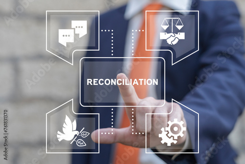 Business man using virtual touch screen presses word: RECONCILIATION. Truth and reconciliation business concept. Reconciliation can be difficult and needs cooperating pieces that fit together.