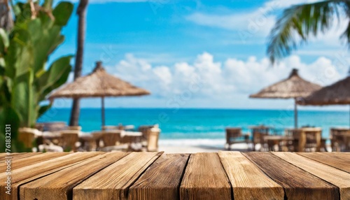 wooden table and blur beach cafes background © Nichole