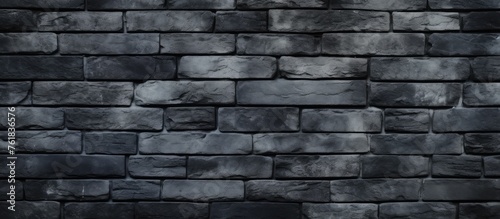 A closeup of a grey rectangular brick wall showcasing the intricate brickwork pattern and mortar. The building material is a composite of bricks and stone, creating a unique flooring texture