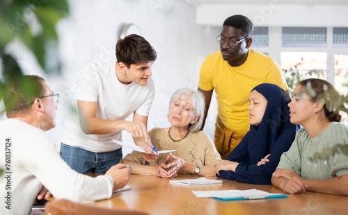 Group students different ages and multinational discussion during business course