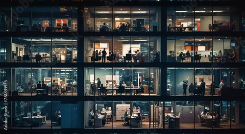 Office work at night in a modern skyscraper with many people photo
