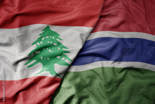 big waving national colorful flag of gambia and national flag of lebanon. photo