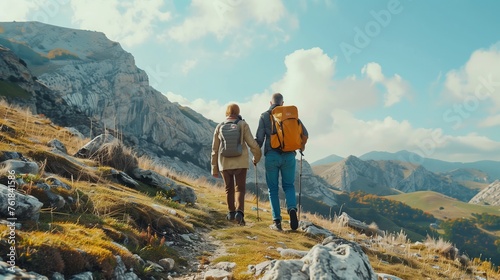 Senior Couple with Backpacks Hiking in Mountains
