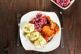 baked chicken leg, mashed potatoes and red cabbage salad