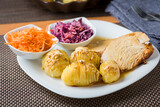 baked hasselback potatoes served with baked fillet and salad