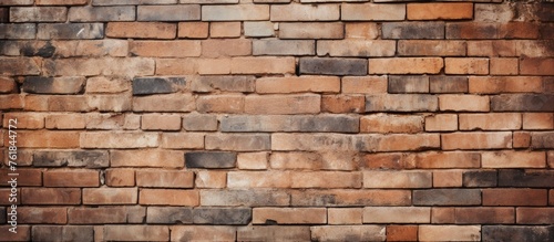 A detailed closeup of a brown brick wall featuring a multitude of rectangular bricks, showcasing the durability and beauty of this building material