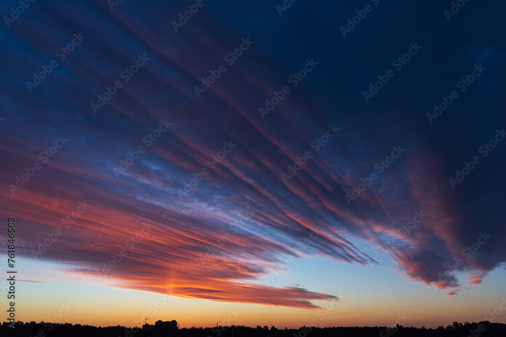 Stunningly beautiful multi-colored violet-pink-lilac evening sky, multi-colored clouds fan out from the lower horizon